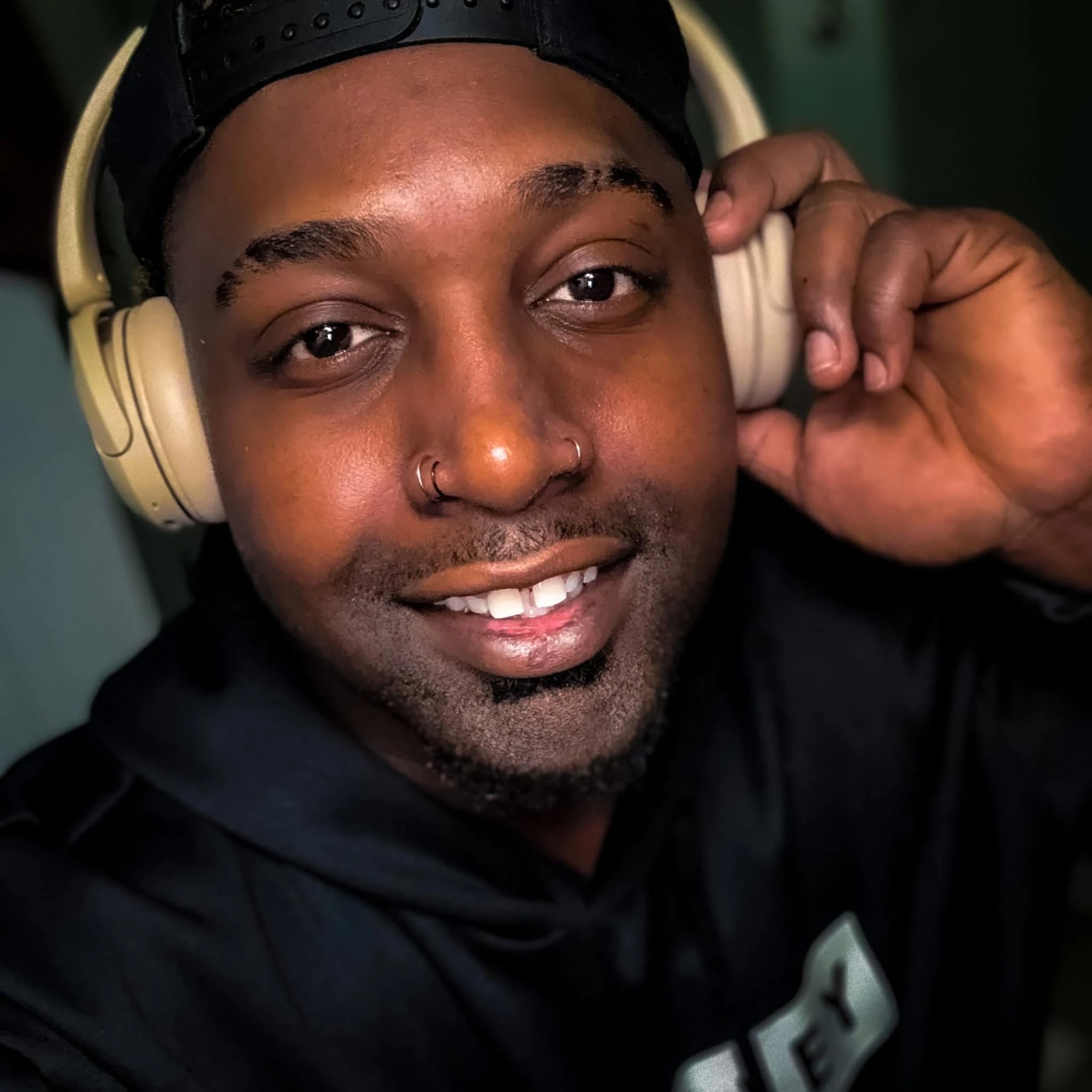 Matthew smiling while wearing headphones