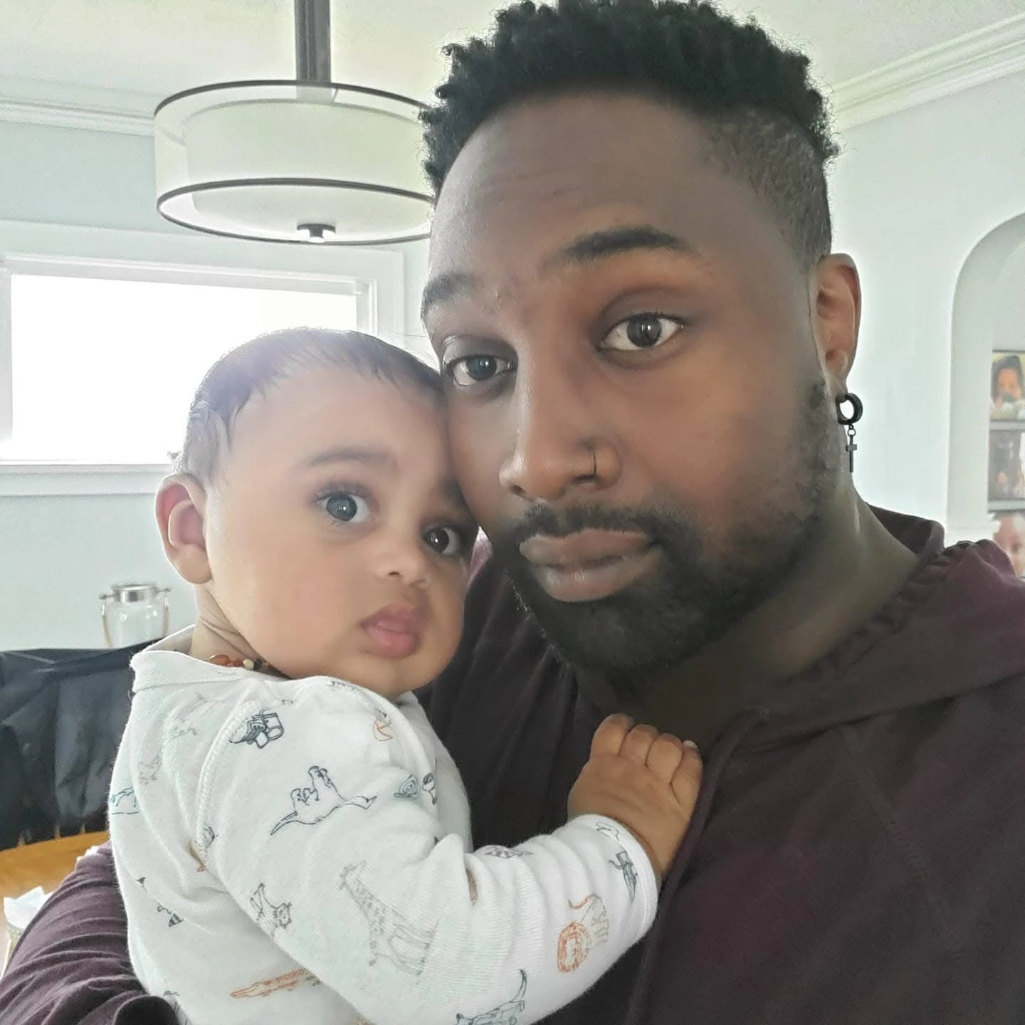 Matthew holding a young child